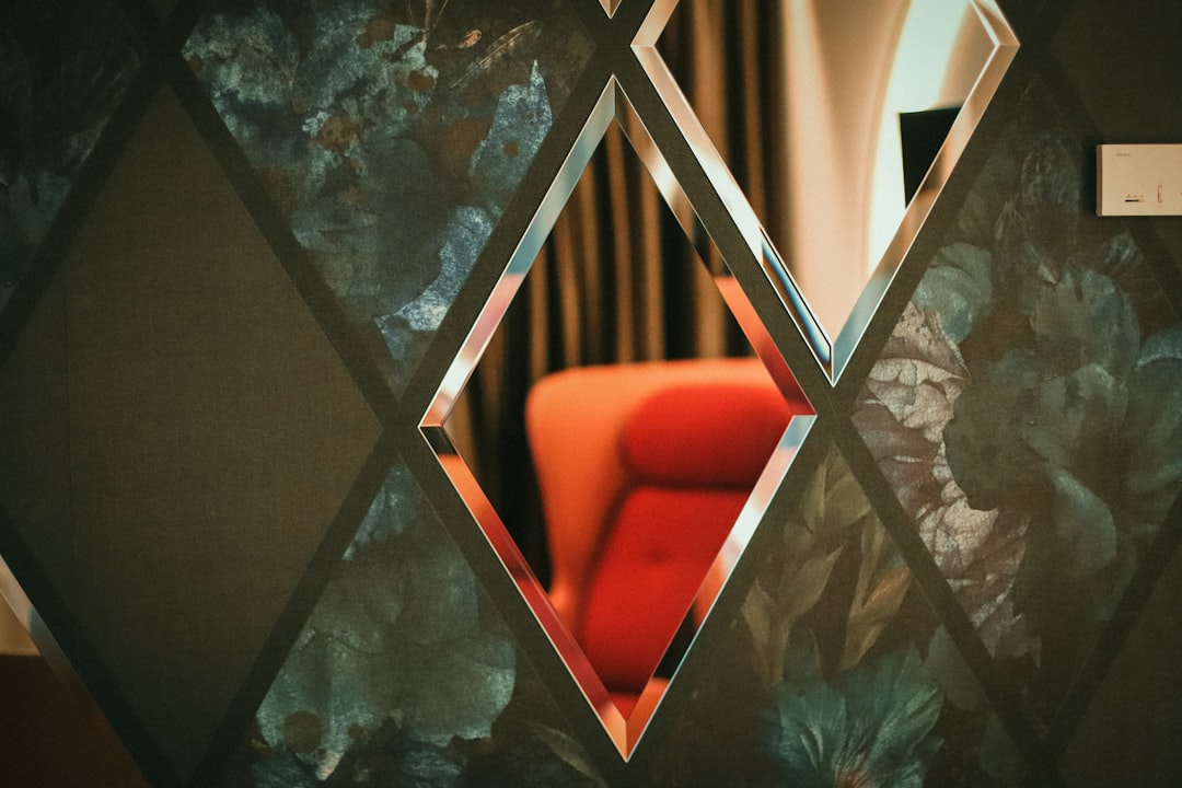 a-red-chair-sitting-in-front-of-a-mirror-ssg8bm-4yd0